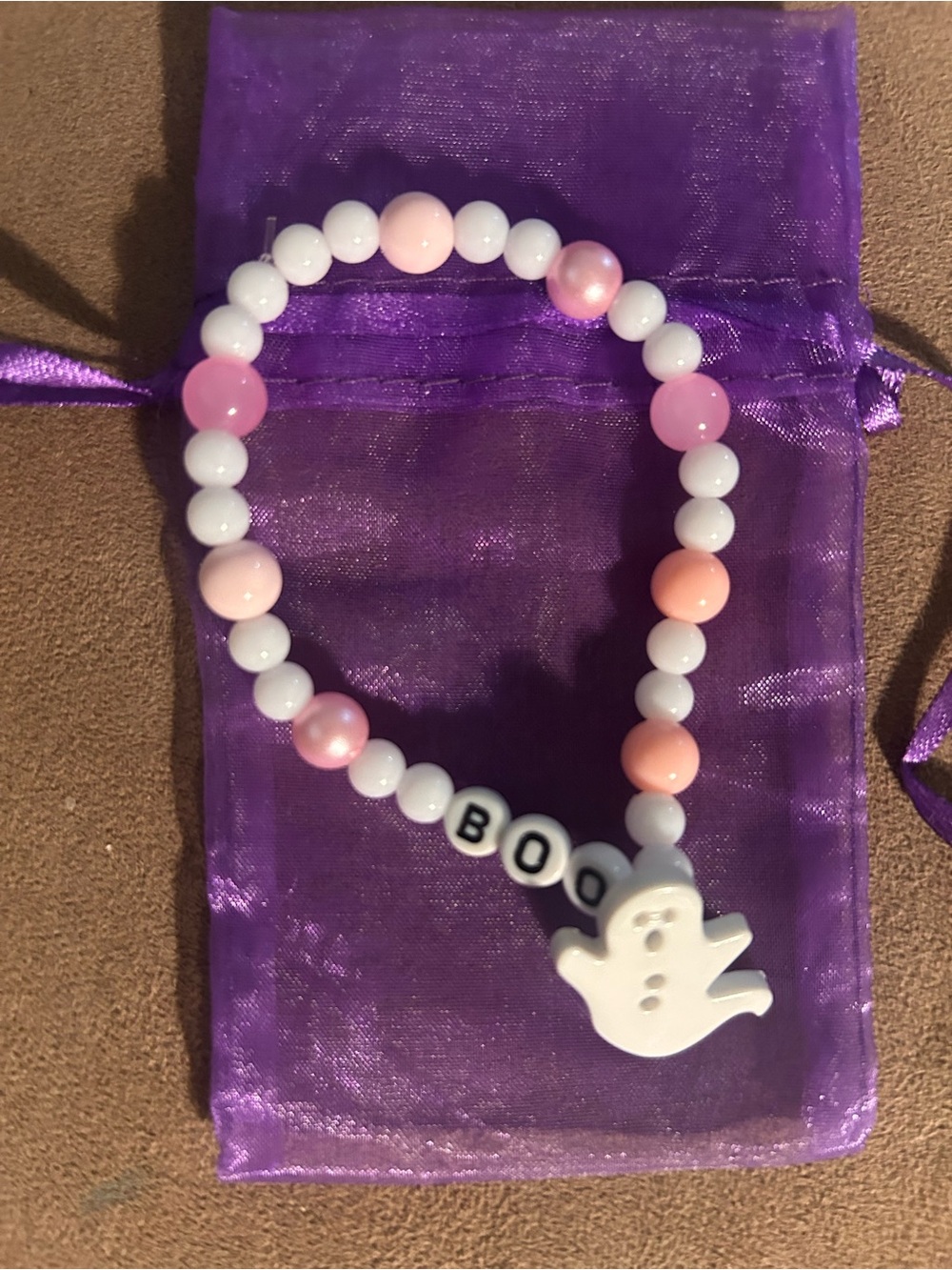 Stretchy Boo bracelet with organza bag.